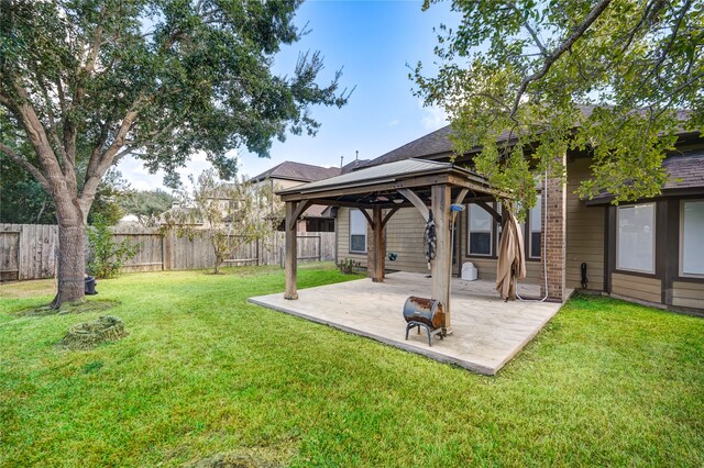 back of house with a gazebo, a yard, and a patio