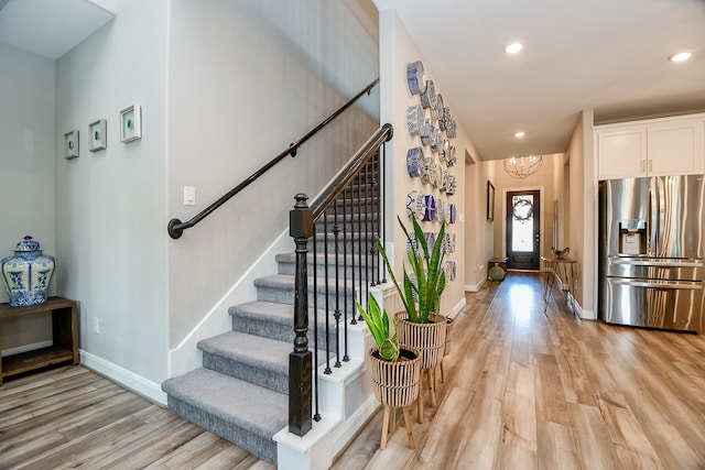 entrance foyer with a notable chandelier and light wood-type flooring