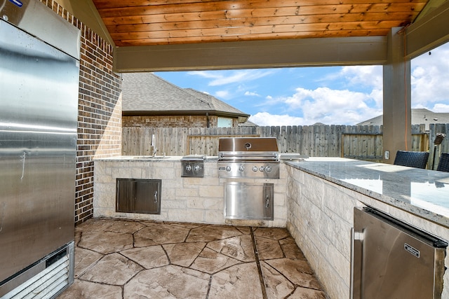 view of patio / terrace featuring area for grilling, exterior kitchen, and sink