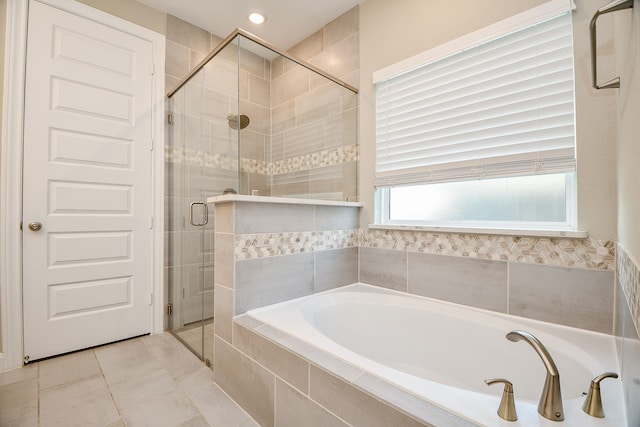 bathroom featuring tile patterned floors and independent shower and bath