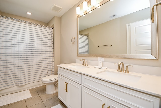 bathroom with tile patterned flooring, vanity, and toilet