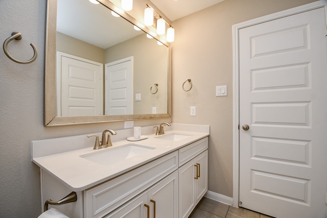 bathroom featuring tile patterned flooring and vanity