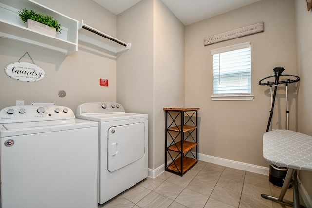 washroom featuring washing machine and dryer and light tile patterned floors