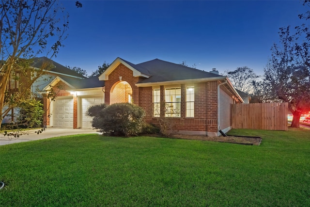 view of front of house featuring a yard and a garage