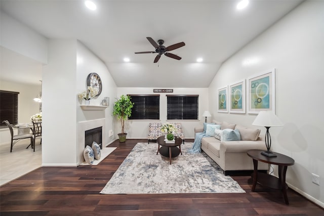 living room with ceiling fan, dark hardwood / wood-style flooring, and lofted ceiling