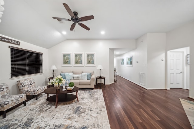 living room featuring vaulted ceiling, ceiling fan, and dark wood-type flooring