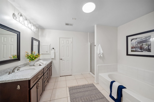 bathroom with tile patterned flooring, vanity, and independent shower and bath