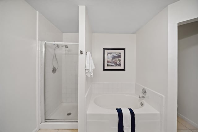 bathroom featuring tile patterned floors and shower with separate bathtub