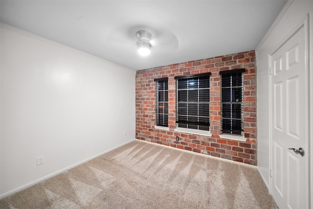 carpeted empty room with ceiling fan and ornamental molding