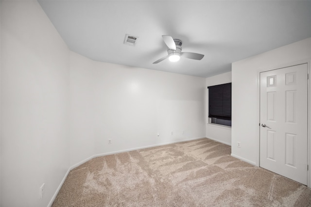 carpeted spare room with ceiling fan