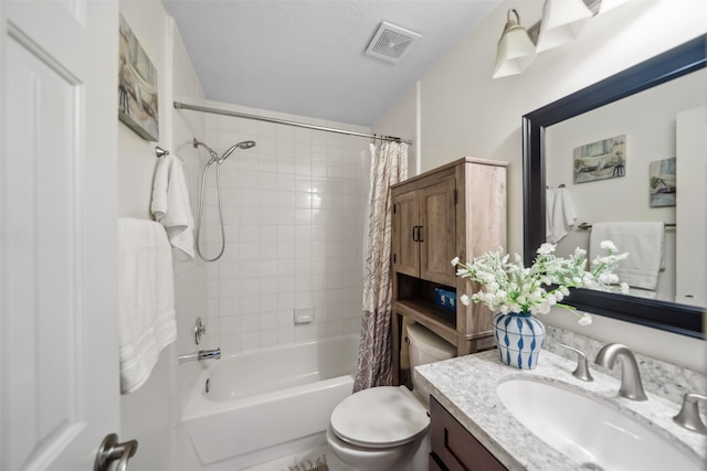 full bathroom with shower / tub combo with curtain, vanity, and toilet