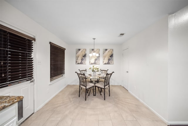 dining space with an inviting chandelier