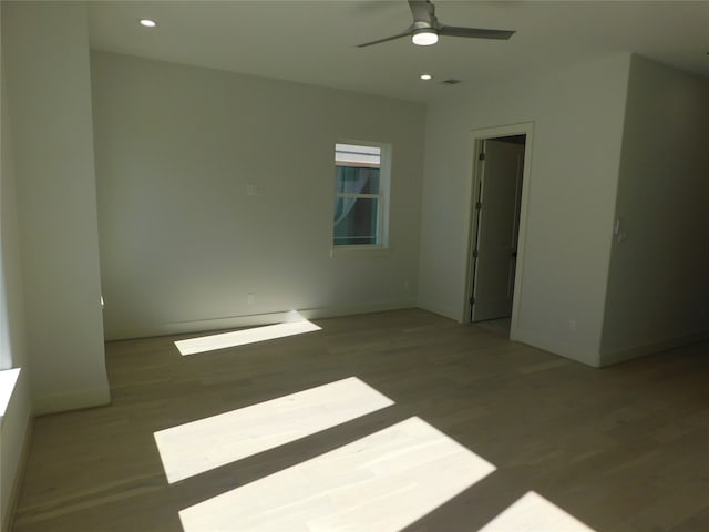 empty room featuring hardwood / wood-style flooring and ceiling fan