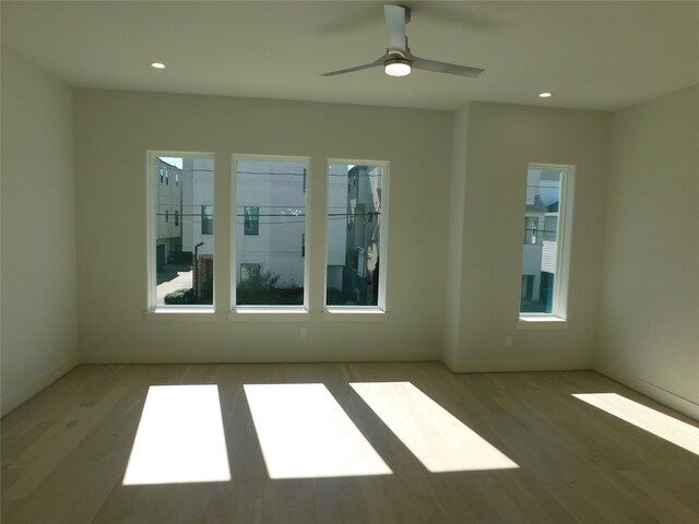 unfurnished room featuring ceiling fan and hardwood / wood-style flooring