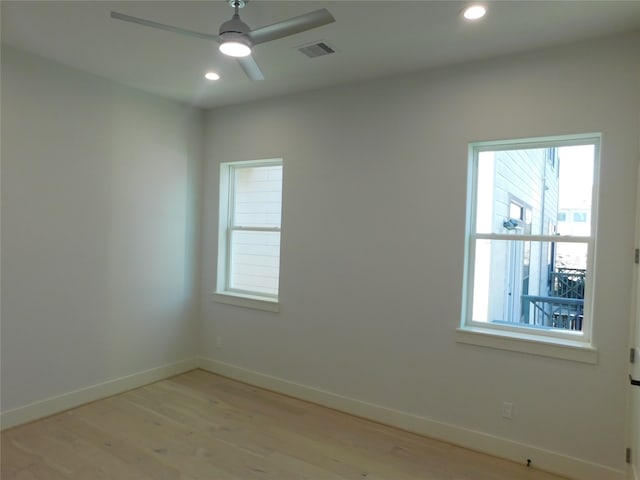 empty room featuring ceiling fan and light hardwood / wood-style flooring