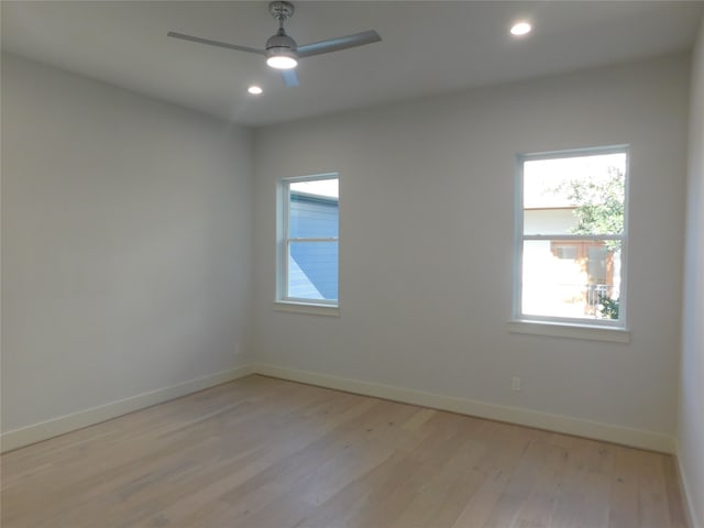 empty room featuring ceiling fan and light hardwood / wood-style floors