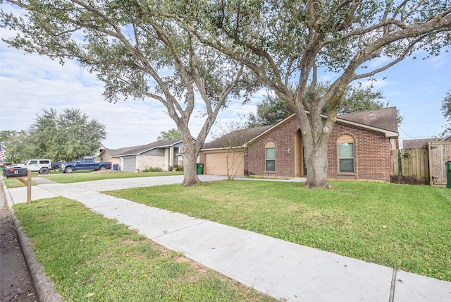 ranch-style house featuring a garage and a front lawn