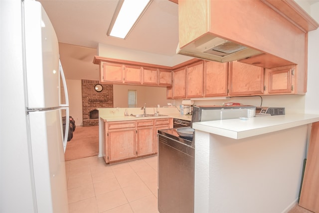 kitchen featuring kitchen peninsula, light brown cabinetry, sink, white refrigerator, and a fireplace