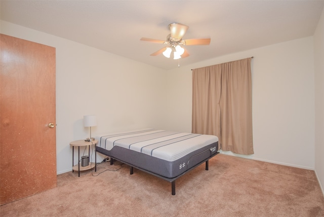 bedroom featuring light colored carpet and ceiling fan