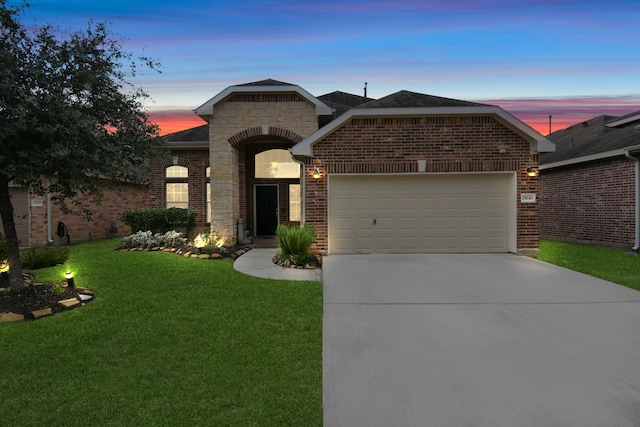 view of front of property with a yard and a garage