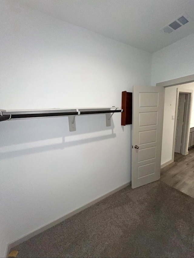 walk in closet with carpet