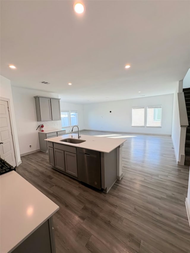 kitchen with dishwasher, a center island with sink, and a wealth of natural light