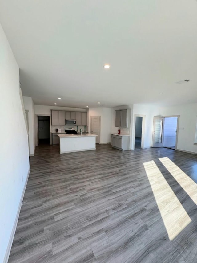 unfurnished living room featuring dark hardwood / wood-style flooring