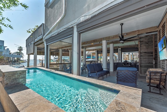 view of pool featuring ceiling fan and an outdoor hangout area