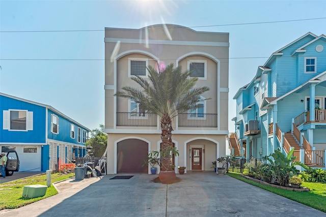 151 Bamaku Bnd, Tiki Island, TX 77554 - townhome / multi-family property featuring concrete driveway, stucco siding, and an attached garage