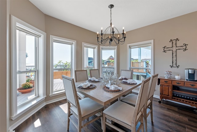 dining space with a chandelier and dark hardwood / wood-style flooring