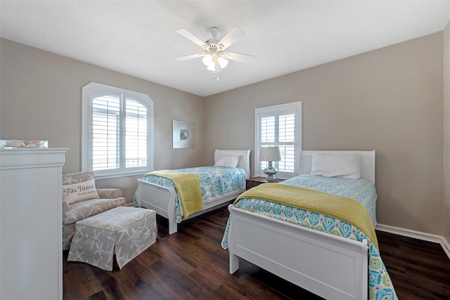 bedroom with ceiling fan and dark wood-type flooring