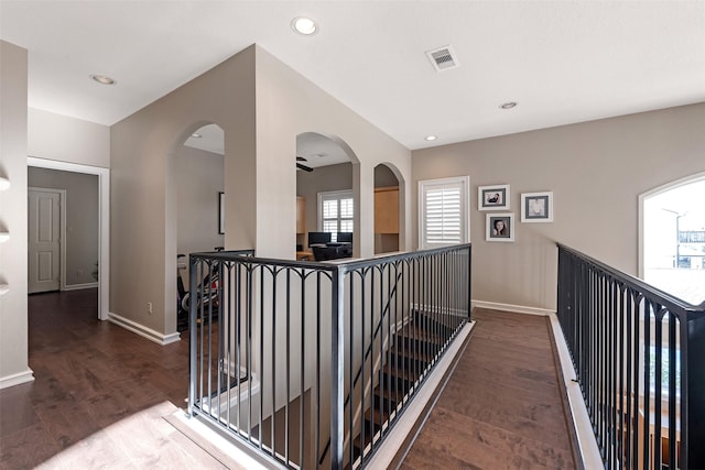 151 Bamaku Bnd, Tiki Island, TX 77554 - corridor with an upstairs landing, baseboards, wood finished floors, arched walkways, and recessed lighting