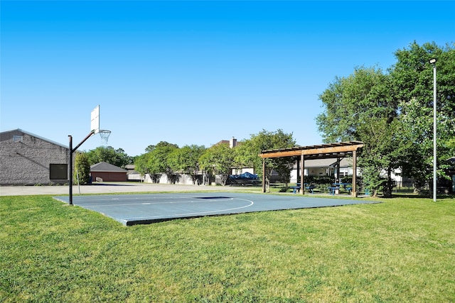 view of sport court with a yard