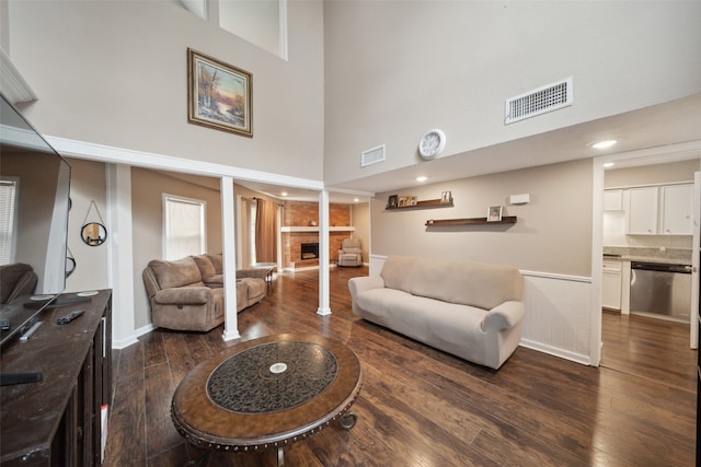 living room featuring dark hardwood / wood-style floors and a high ceiling