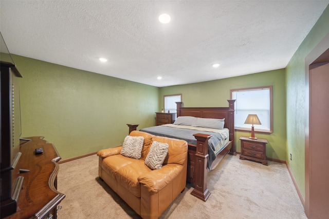 carpeted bedroom with a textured ceiling and multiple windows