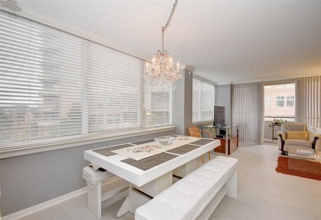 dining area with ornamental molding and a notable chandelier