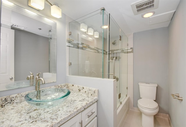 full bathroom featuring tile patterned floors, vanity, toilet, and combined bath / shower with glass door