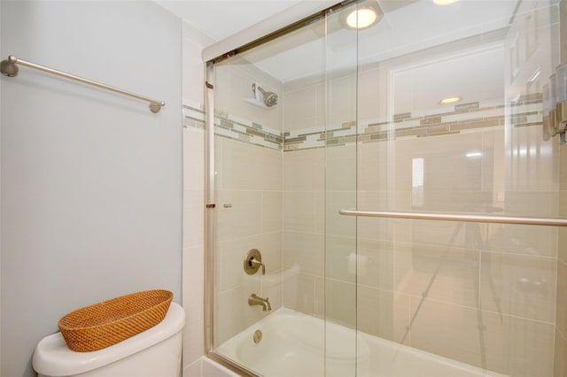 bathroom featuring bath / shower combo with glass door