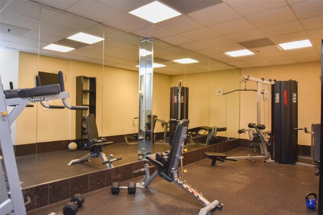 exercise room featuring a paneled ceiling