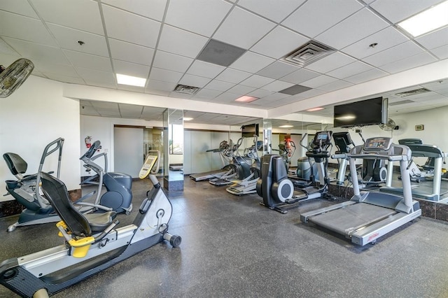 exercise room with a paneled ceiling