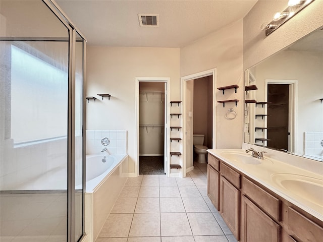 full bathroom with tile patterned flooring, vanity, toilet, and shower with separate bathtub