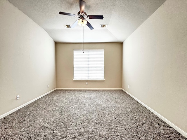 carpeted spare room with a textured ceiling, ceiling fan, and lofted ceiling