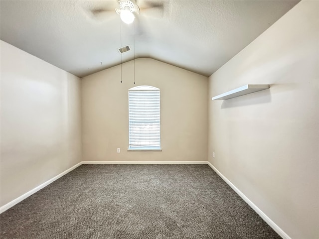 carpeted spare room featuring ceiling fan, a textured ceiling, and vaulted ceiling