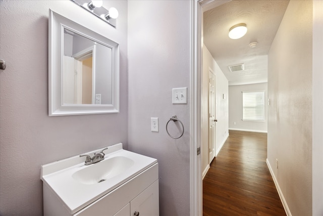 bathroom featuring hardwood / wood-style floors and vanity