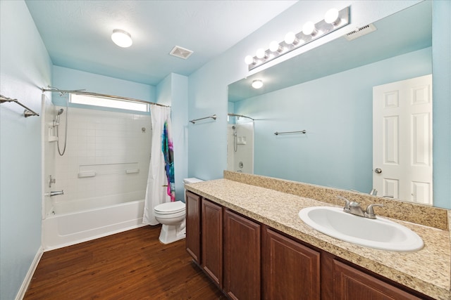 full bathroom featuring shower / bath combo, vanity, hardwood / wood-style flooring, and toilet