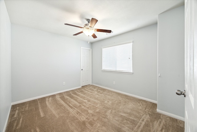 spare room with carpet and ceiling fan