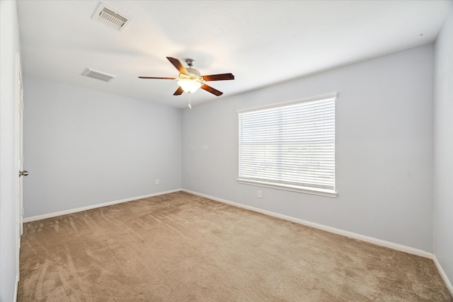 empty room with ceiling fan and light colored carpet