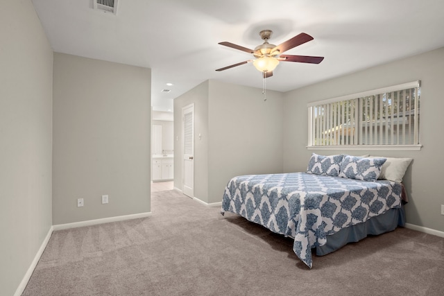 carpeted bedroom featuring connected bathroom and ceiling fan