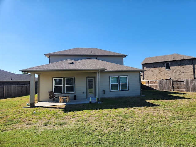 back of house with a lawn and a patio