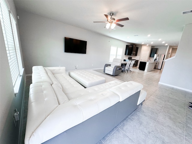 tiled living room featuring ceiling fan